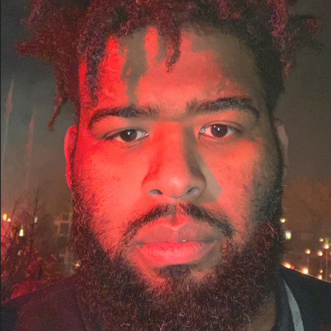 Allen with a red lit glow on the left side of his face