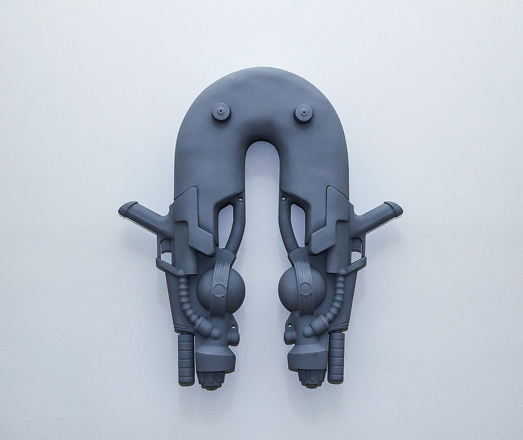 sculpture made of supersoaker type toys, and foam painted grey