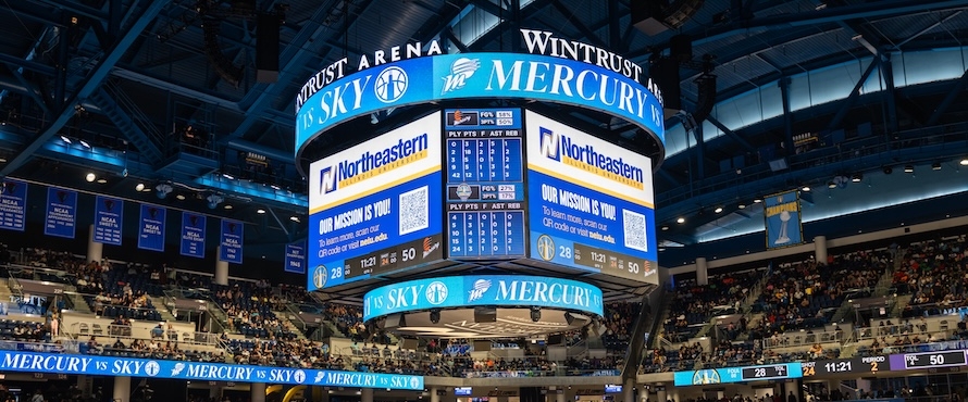A photo of the jumbotron at Wintrust Arena with the Northeastern Illinois University logo.