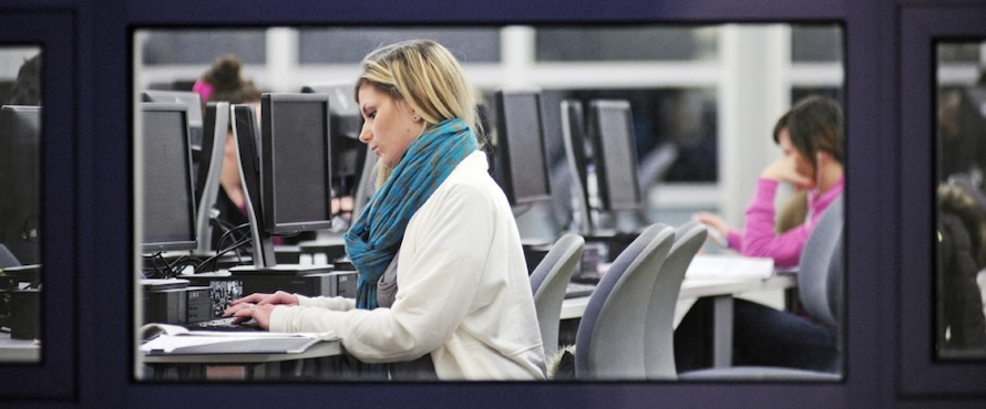 A photo of a person typing in a computer lab on Northeastern Illinois University's Main Campus. 