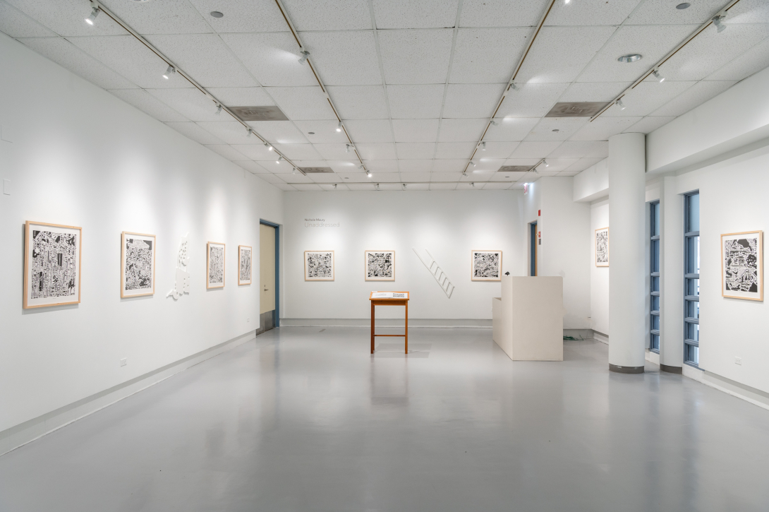 Long shot of gallery with artwork hanging on walls