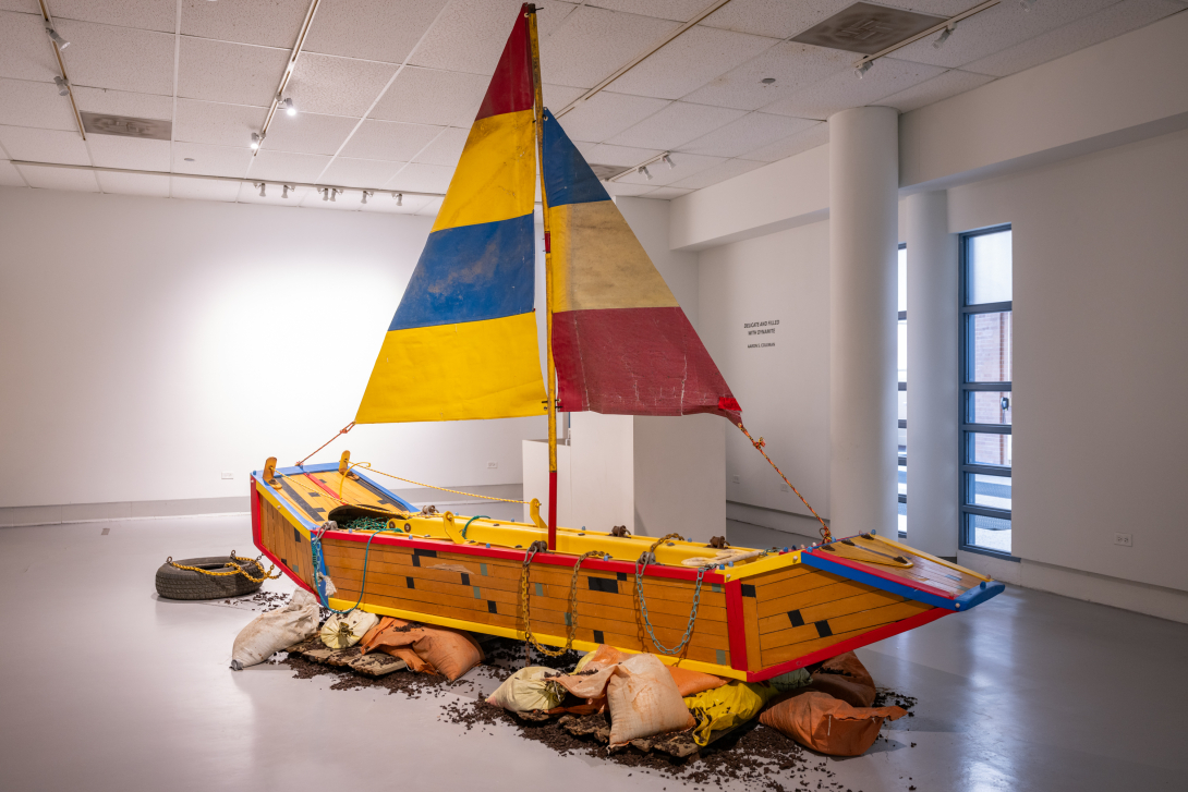 large boat in yellows, red and blues in gallery