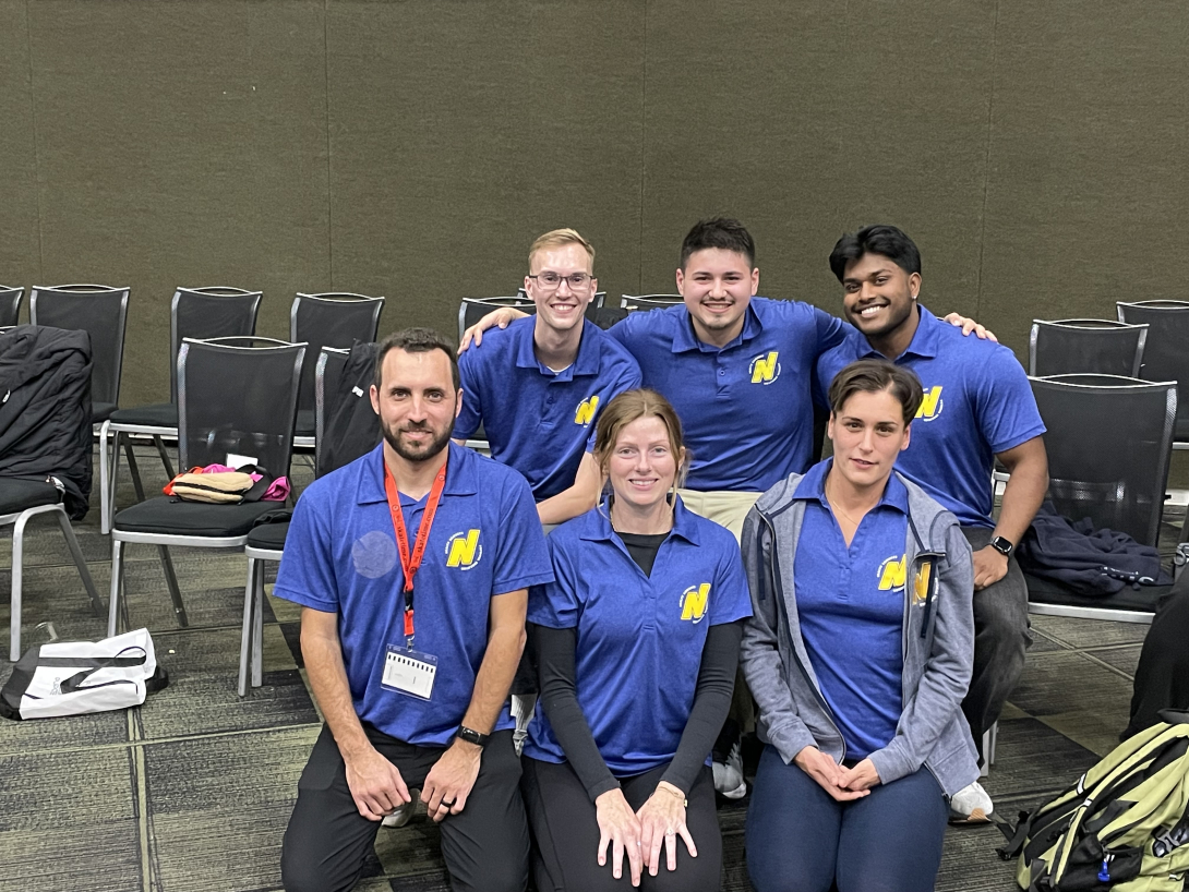 group of 6 students sitting and kneeling