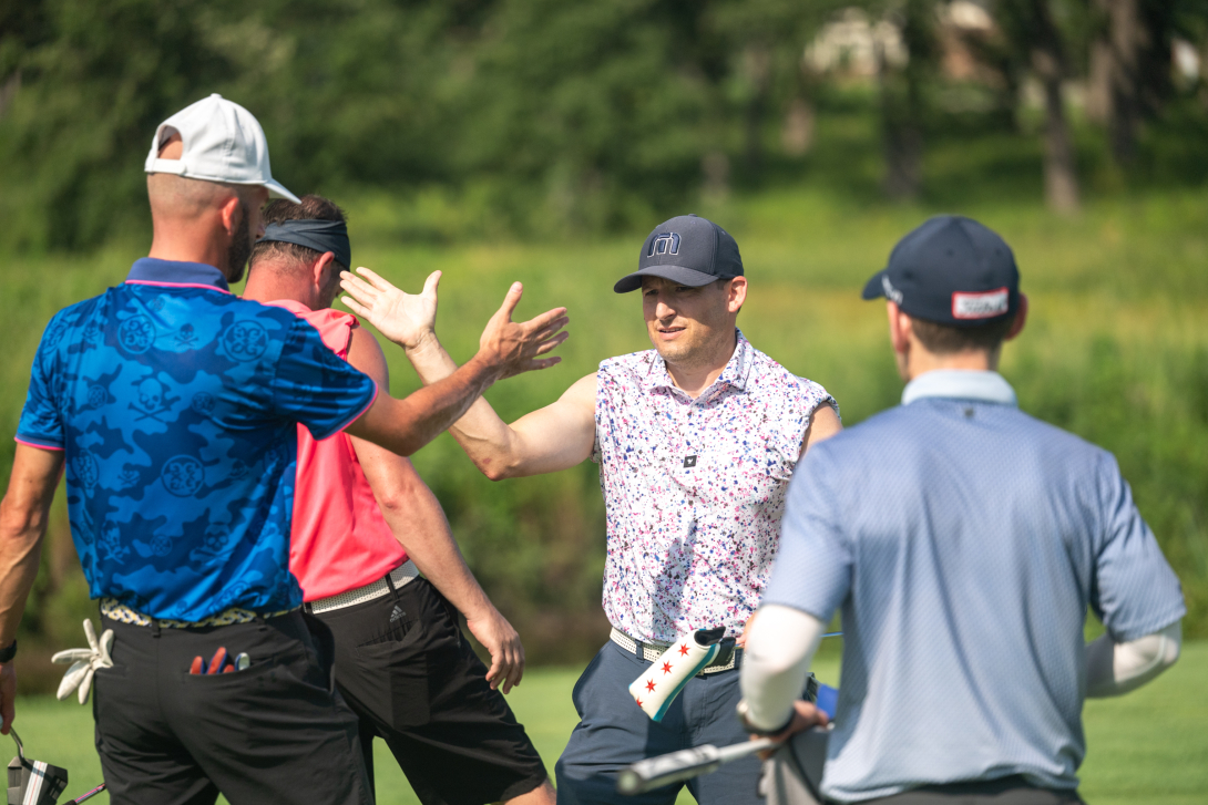 Kane golfers high five on the green