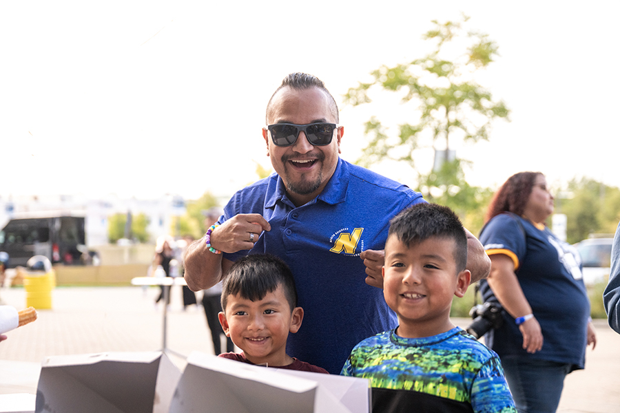 Man posing with two boys