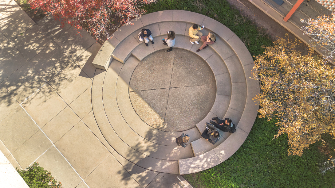 Aerial view of students sitting in the circle.