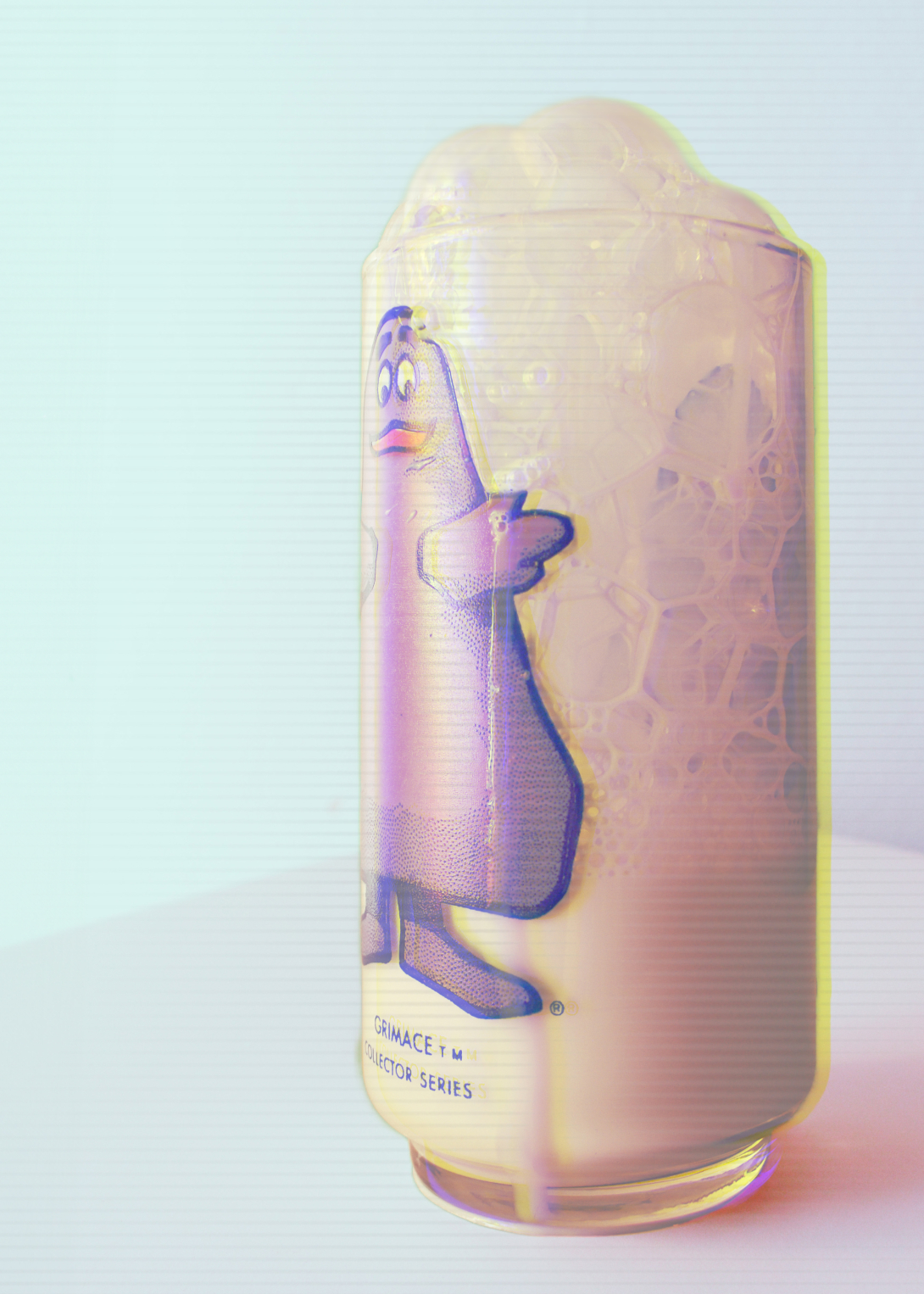 photograph of cartoon printed glass cup with frothy chocolate milk inside