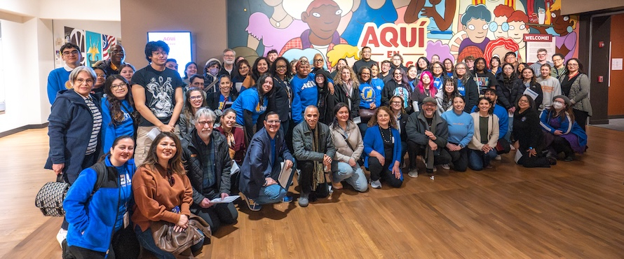 A group photo of Northeastern Illinois University students and employees at the Chicago History Museum's “Aquí en Chicago” exhibit.