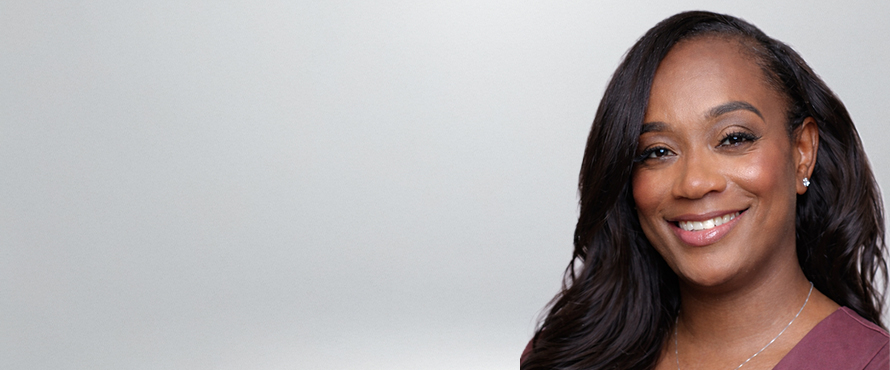 A headshot photo of Tonija Neal, smiling, against a gray background.