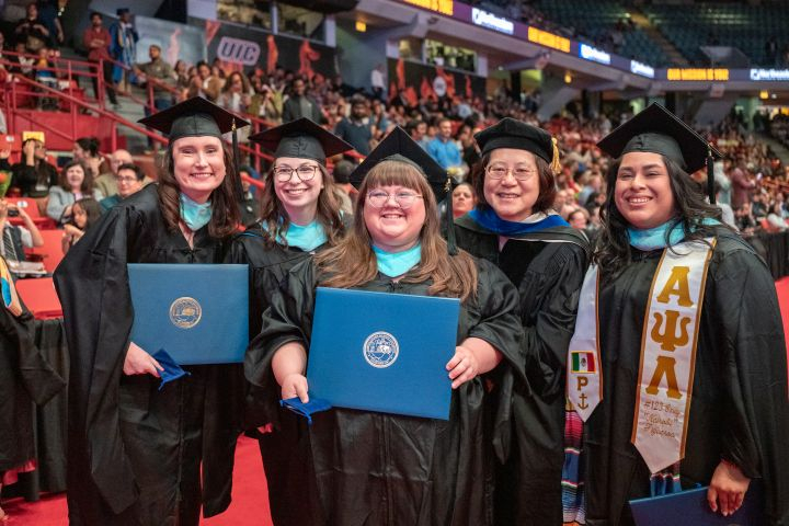 Spring 2026 Graduate Students Posing with Diploma Covers