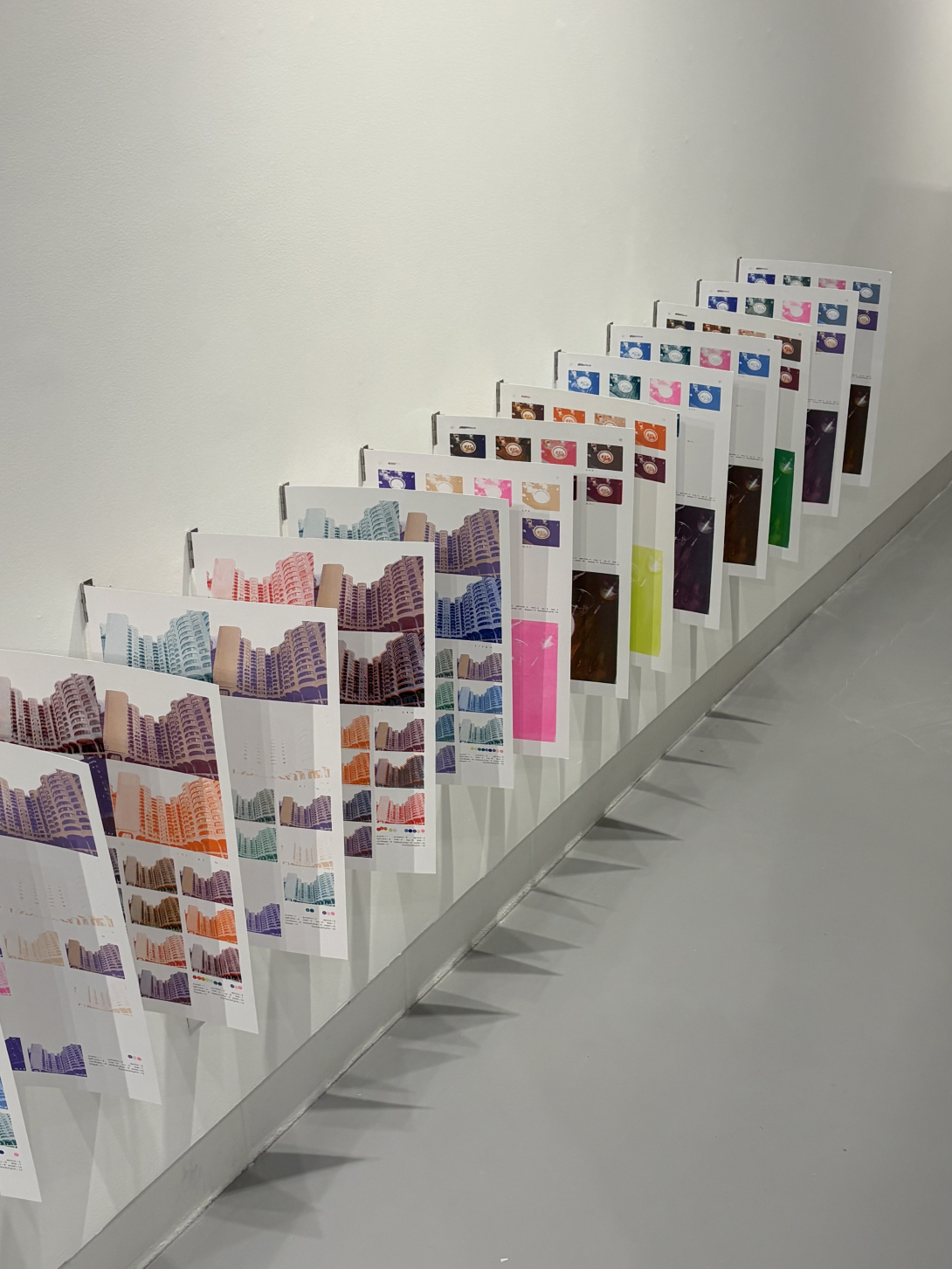 riso printed posters displayed near one another, perpendicular on a wall