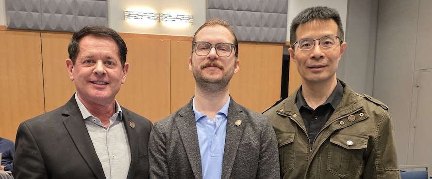 A photo of Northeastern Illinois University Interim Provost and Vice President for Academic Affairs R. Shayne Cofer, Ph.D., with Garo Agopian, Ph.D., and  Sheng Liu, Ph.D., as they received promotions to Associate Professor during the April 16, 2026 Northeastern Board of Trustees meeting. 