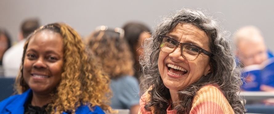 A photo of Northeastern Illinois University employees smiling at the 2026 Employee Excellence and Years of Service Awards ceremony.