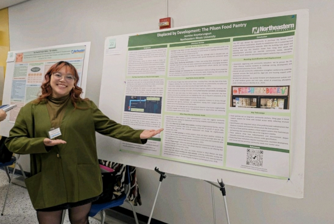 Student standing in front of research poster.