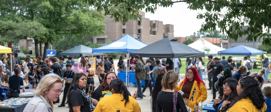 A photo of Northeastern Illinois University students and employees enjoying the Fall 2025 Welcome Day fair on the University Commons of the Main Campus.