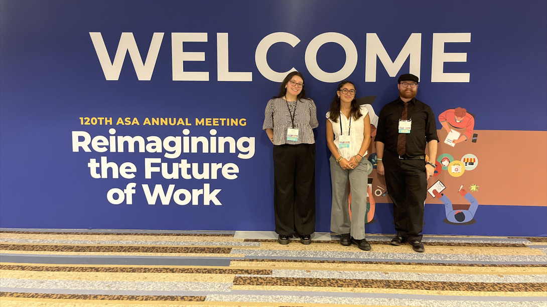 Three people posing for photo at workshop.