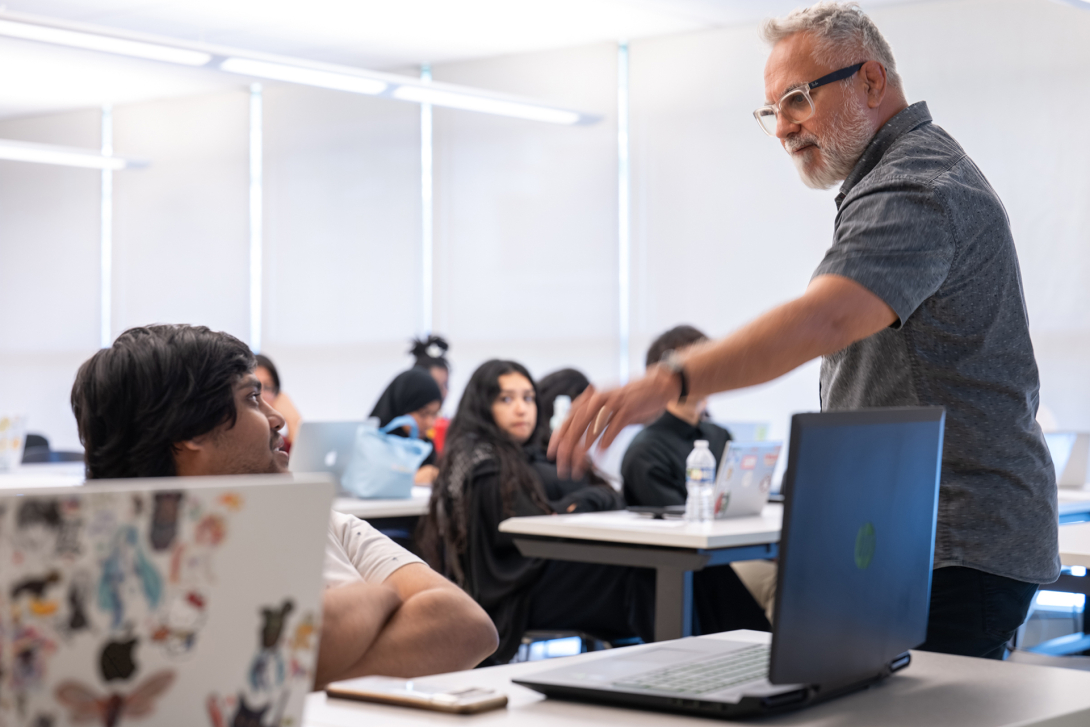 Professor teaching a course with students listening.