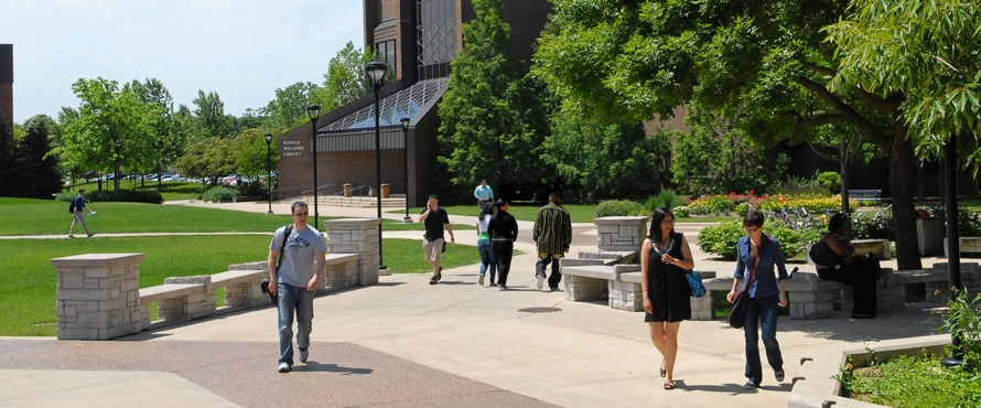 A photo of people walking along the University Commons on Northeastern Illinois University's Main Campus on a sunny day.  