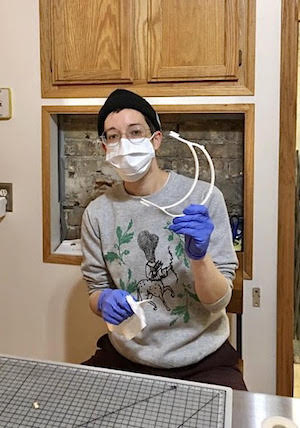 A person is shown wearing a surgical mask.
