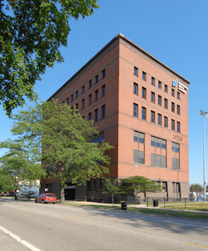 The red brick Carruthers Center building is shown under a blue sky.