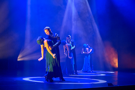 Six Ensemble Español dancers perform on the stage.