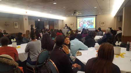 People sitting at tables in the Golden Eagles Room celebrating the First Year Experience Program