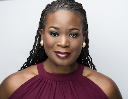 LaToya Lain smiles into the camera in front of a white background.