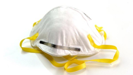 An white N95 respirator mask with yellow straps