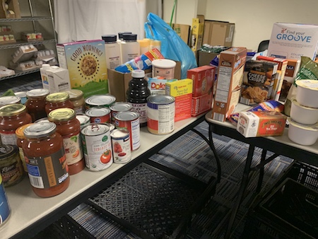 Non-perishable food is shown stacked on a table.