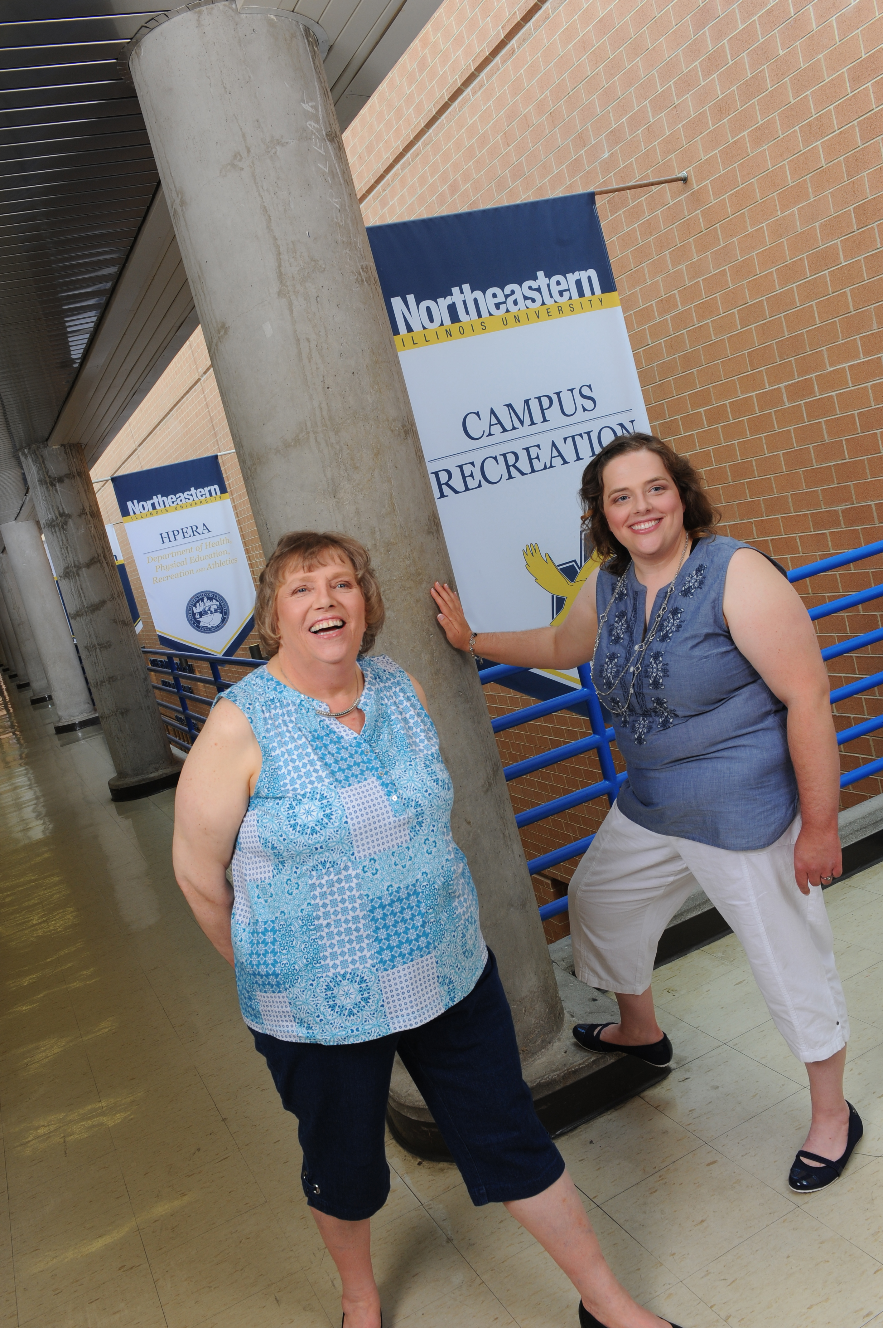 Jean and Angelina posing in the campus recreation center