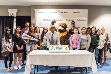 Admissions Director Lamont Vaughn and Goldie pose with a group of newly admitted students