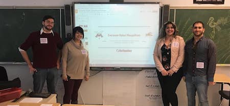 NEIU students Cameo Chilcutt, Michael Konecki, Assil Shawkat and Samah Slim stand in a classroom in front of a projection screen