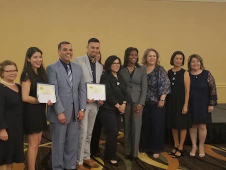 Graduate students Cynthia Bautista and Ken Cuellar stand among 10 recipients of the Principal-On-Training scholarship