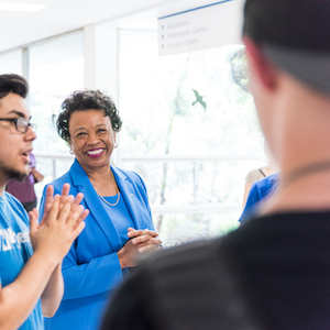 President Gloria J. Gibson smiles while talking with students.