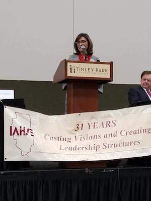 Ana Gil Garcia speaks at a podium.