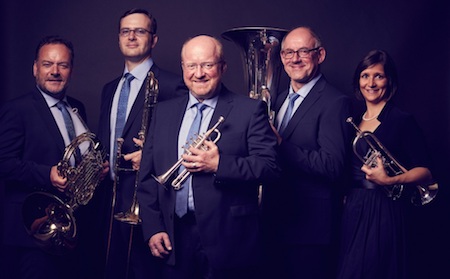 The five members of Harmonic Brass pose holding their instruments