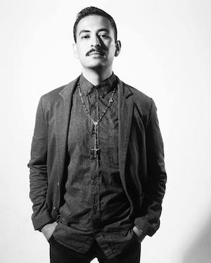 Poet Marcelo Hernandez Castillo faces the camera in this black and white photo