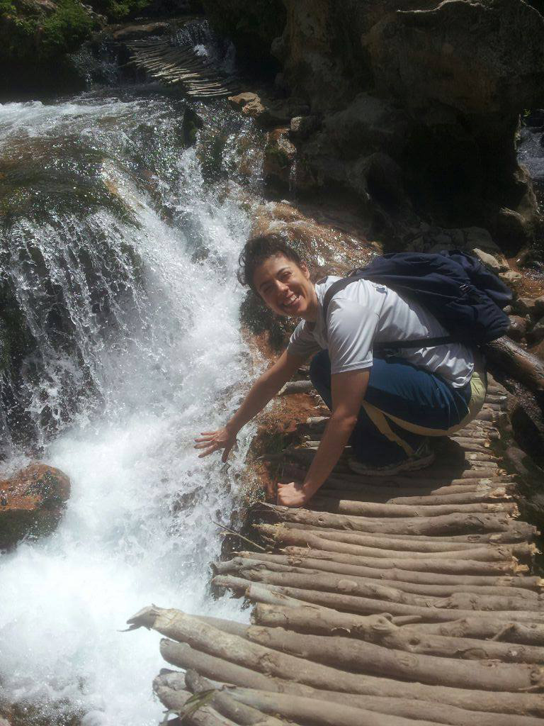 Stacy Alikakos near a waterfall